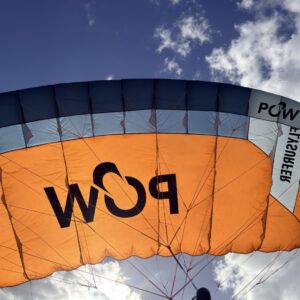 Used Flysurfer POW 4.0m parawing flying, orange canopy against a blue sky